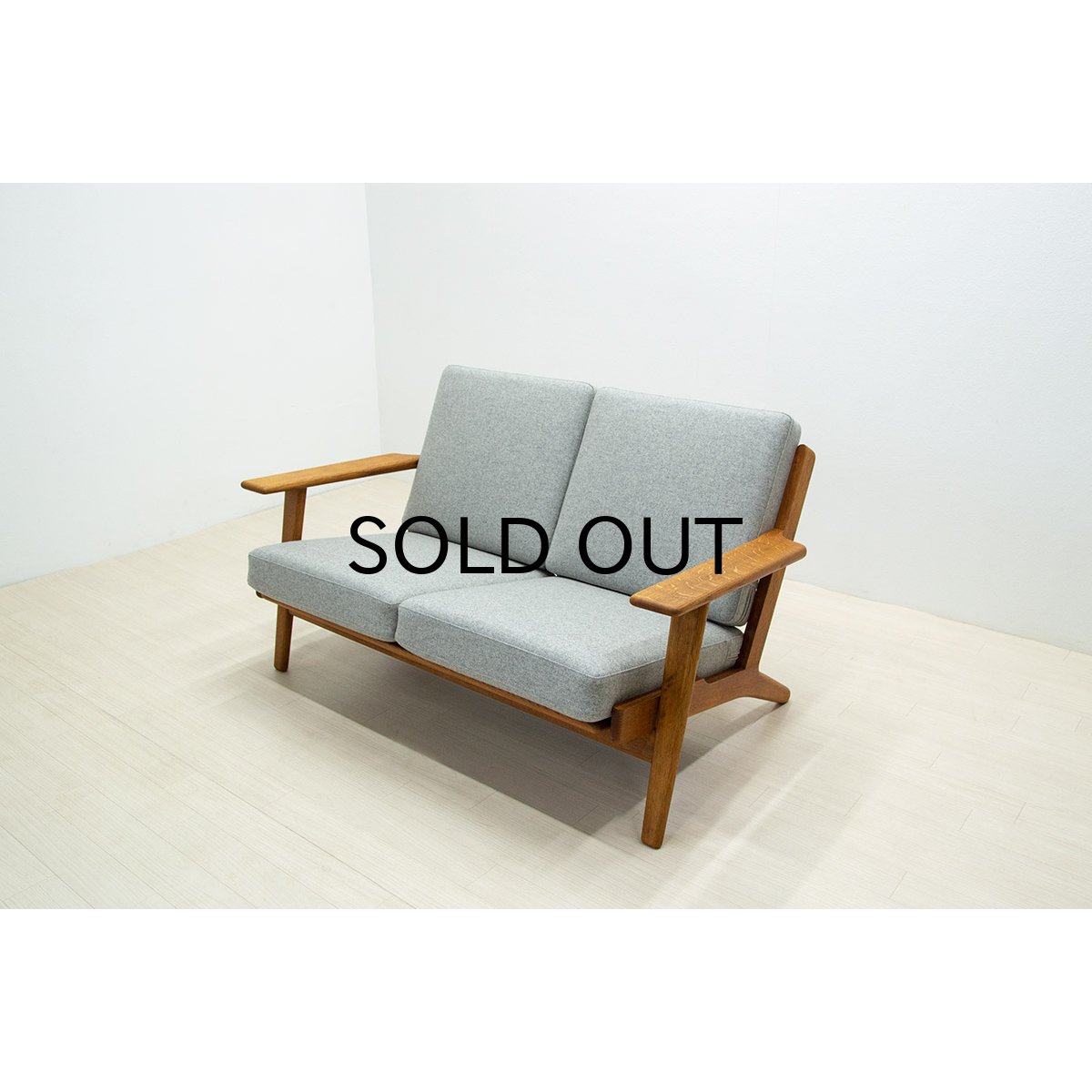 A SET OF FOUR JH513 ARMCHAIRS IN OAK BY HANS WEGNER FOR